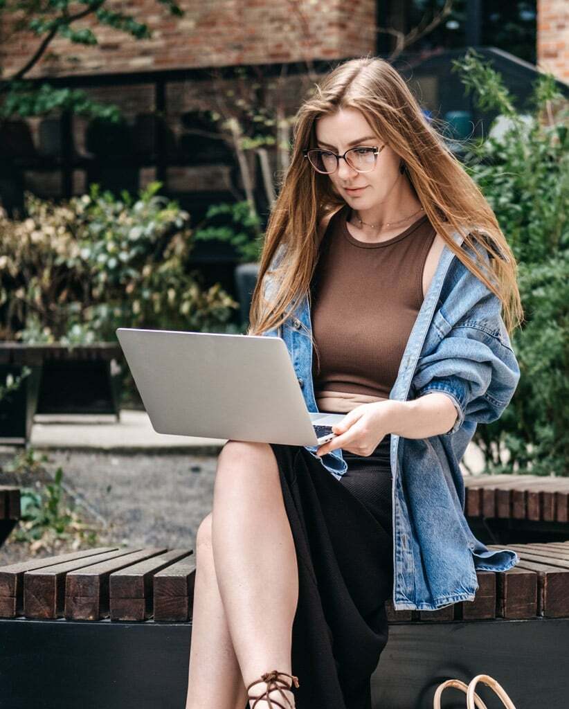 professional-woman-using-laptop-in-garden-setting